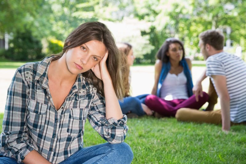 Lonely student feeling excluded on campus at the university